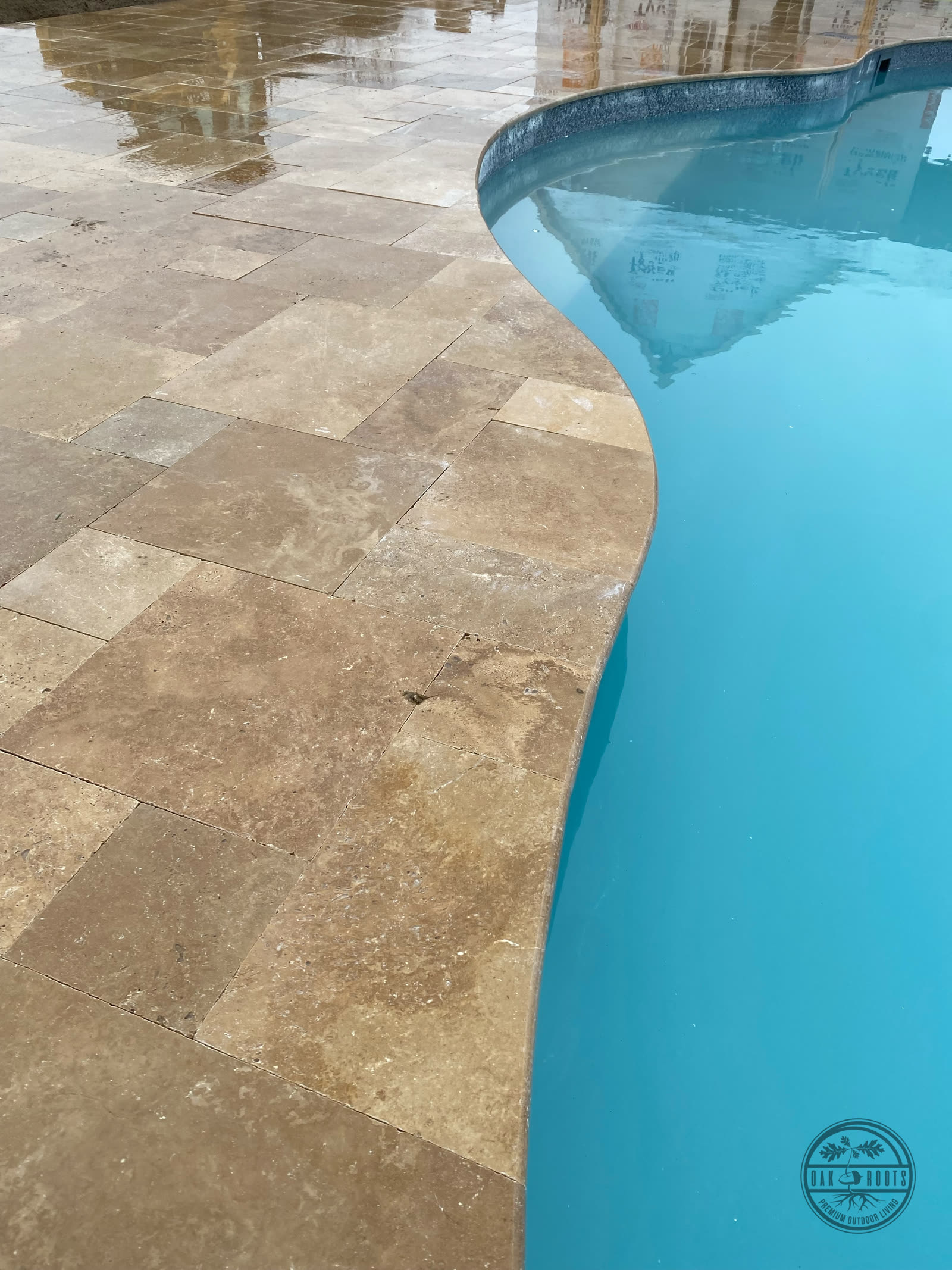 Travertine pool deck and marble pavers by Oak Roots LLC