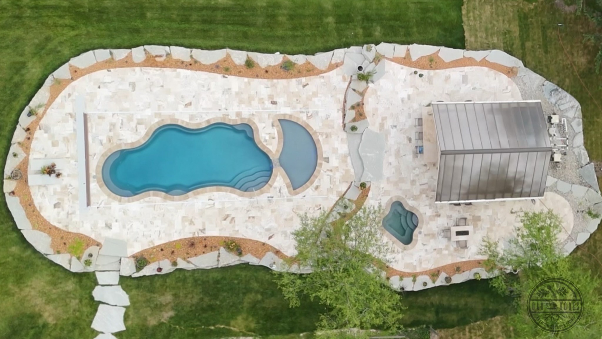 Travertine pool deck and marble pavers by Oak Roots LLC