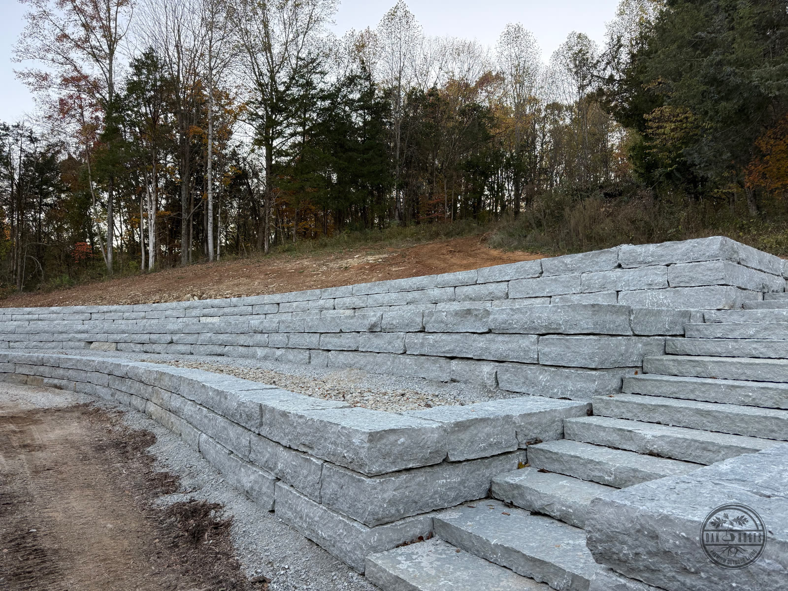 Natural limestone retaining wall by Oak Roots LLC