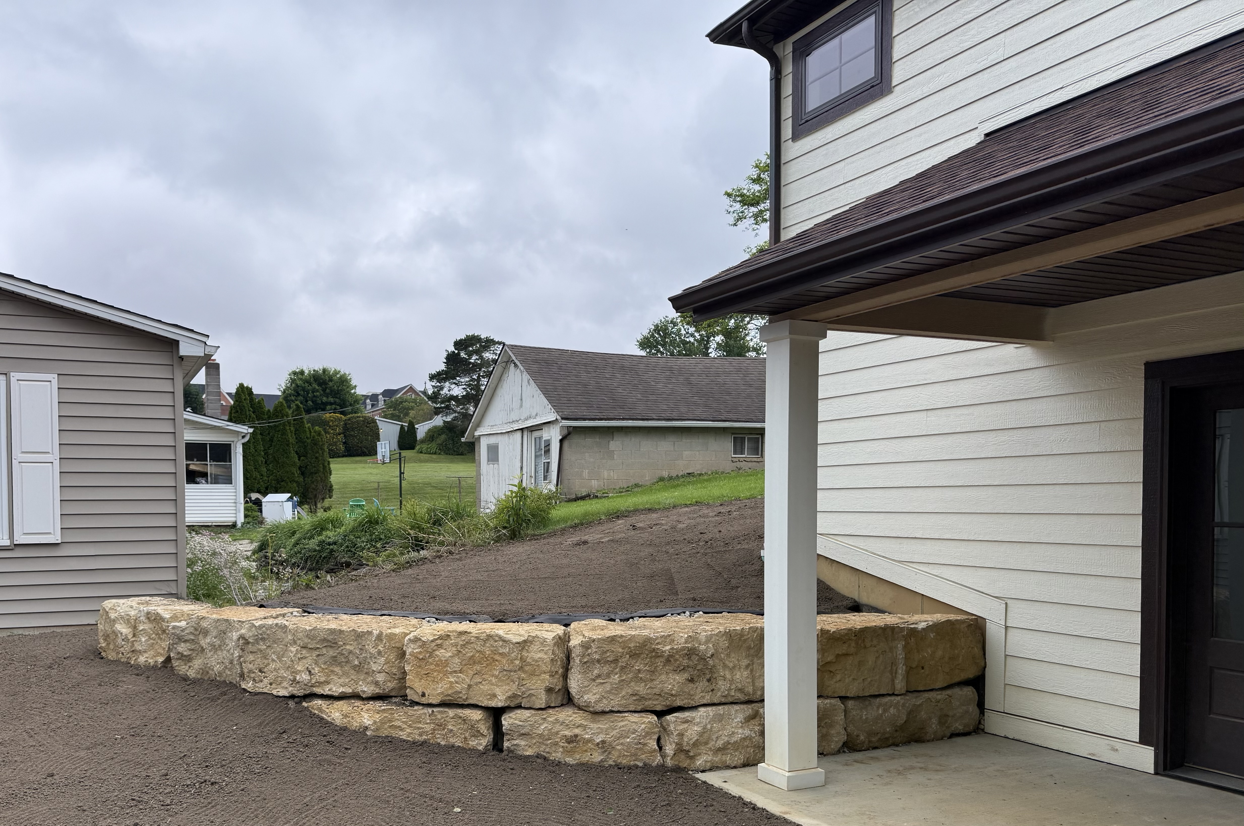 Retaining wall elevated patio by Oak Roots LLC Milan Indiana